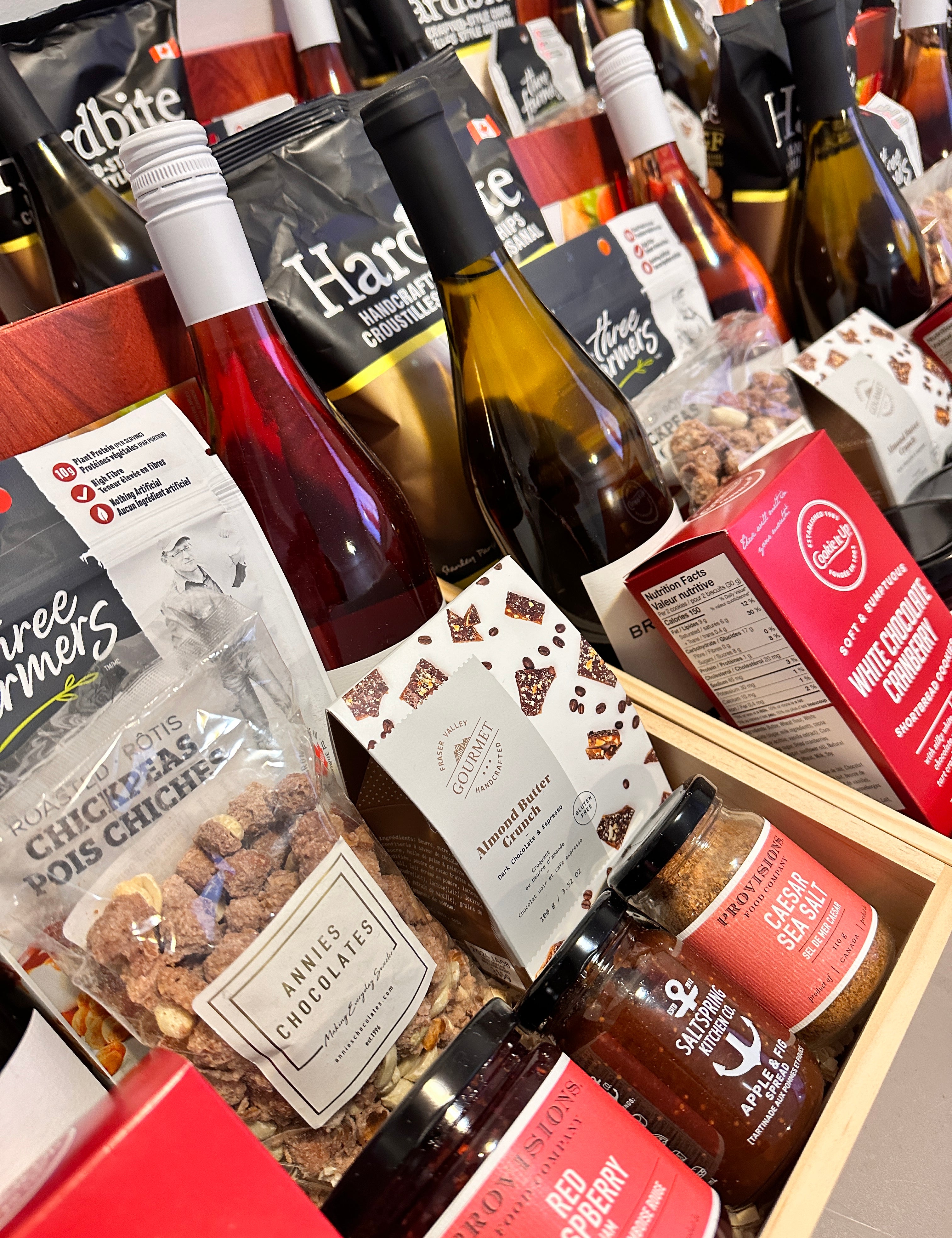 Gourmet gift boxes by Muse Baskets and Co. featuring premium Canadian snacks, artisanal chocolate, wine, and condiments — ideal for corporate gifting, celebrations, and client appreciation.
