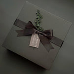 Luxe black gift box with satin ribbon and handwritten notecard – Muse Baskets & Co. Thinking of You collection.