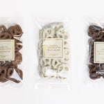 Three packages of Annie's Chocolates on a white background