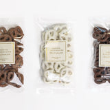 Three packages of Annie's Chocolates on a white background