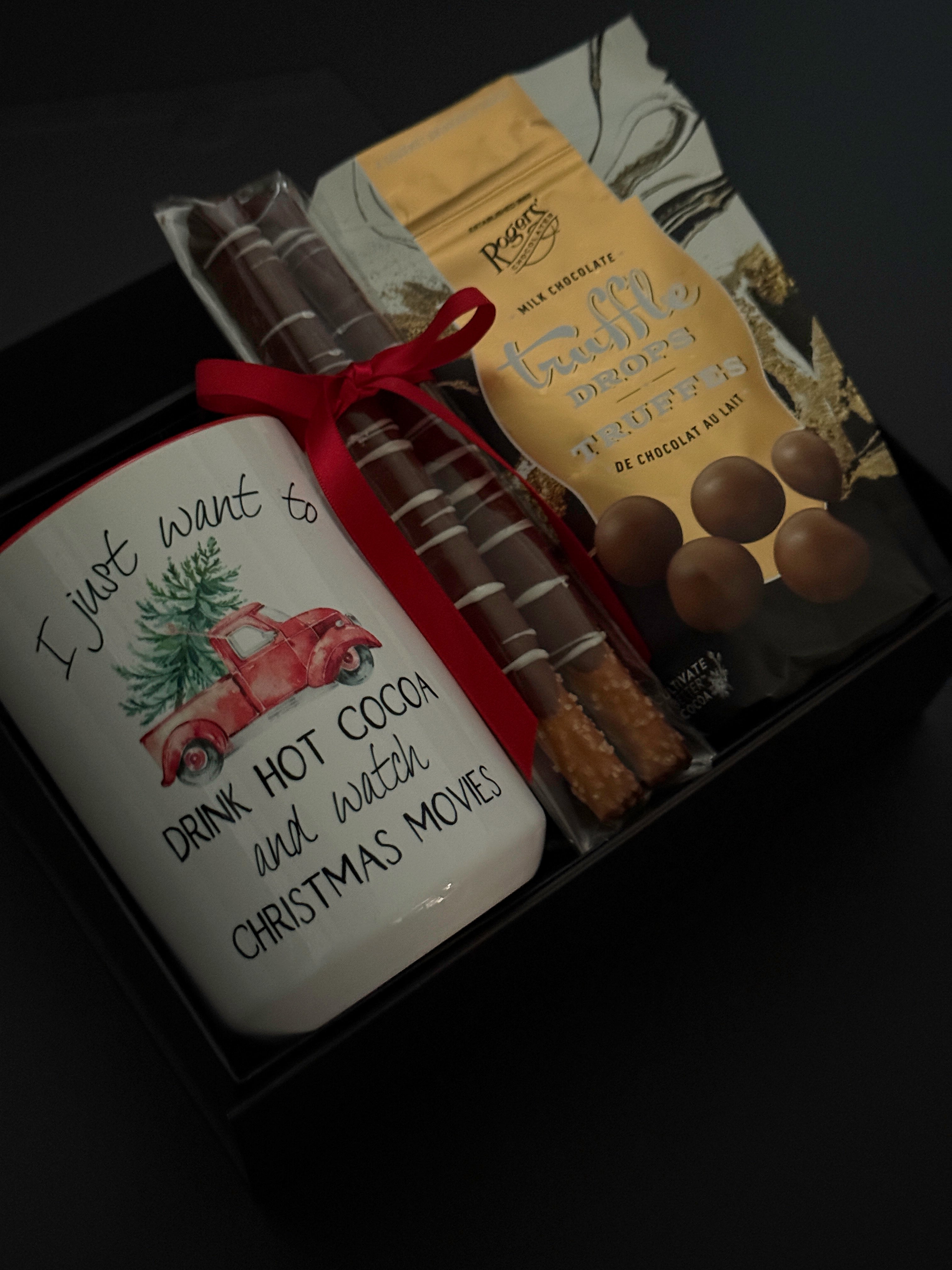 Teacher holiday gift box with hot chocolate truffle drops, chocolate pretzels, and mug.