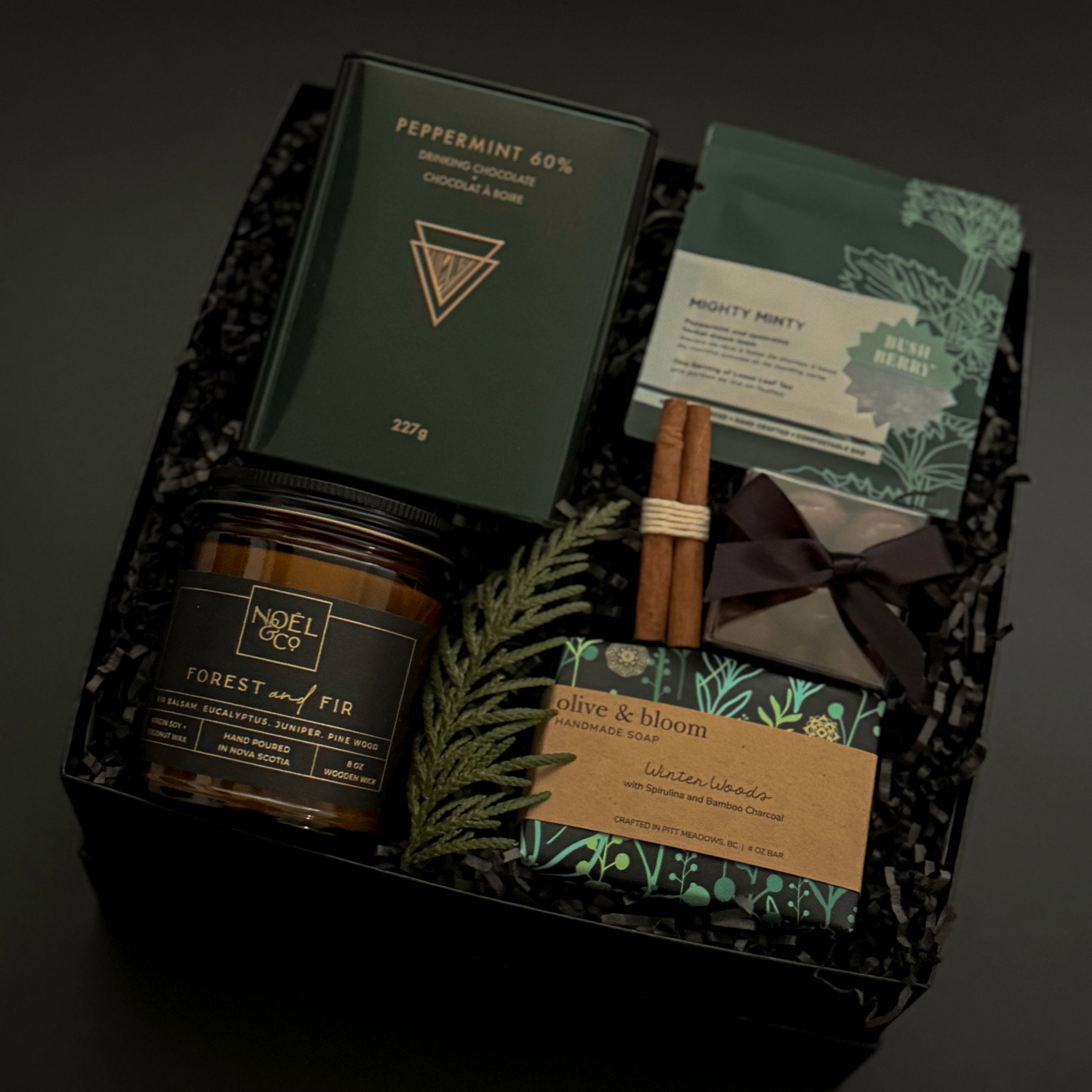 Gift set with candles, incense, and packaging on a dark background