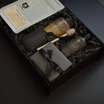 A luxe Solenne gift box arranged with artisanal coffee, honey, stoneware mug, maple syrup, and pâté on a soft neutral backdrop.