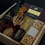 Curated Canadian artisan holiday gift box with preserves, almonds, and candle.