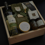 Luxury corporate client gift box featuring wine, Brie, jam, dipping dish, candle, and chocolate in a wood box,  ideal for realtors, law firms, and design studios.