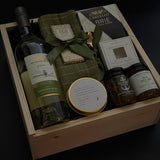 Luxury corporate client gift box featuring wine, Brie, jam, dipping dish, candle, and chocolate in a wood box,  ideal for realtors, law firms, and design studios.