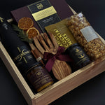 Corporate holiday gift box with sparkling cava, artisan chocolates, and festive accents.