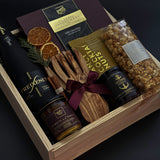 Corporate holiday gift box with sparkling cava, artisan chocolates, and festive accents.
