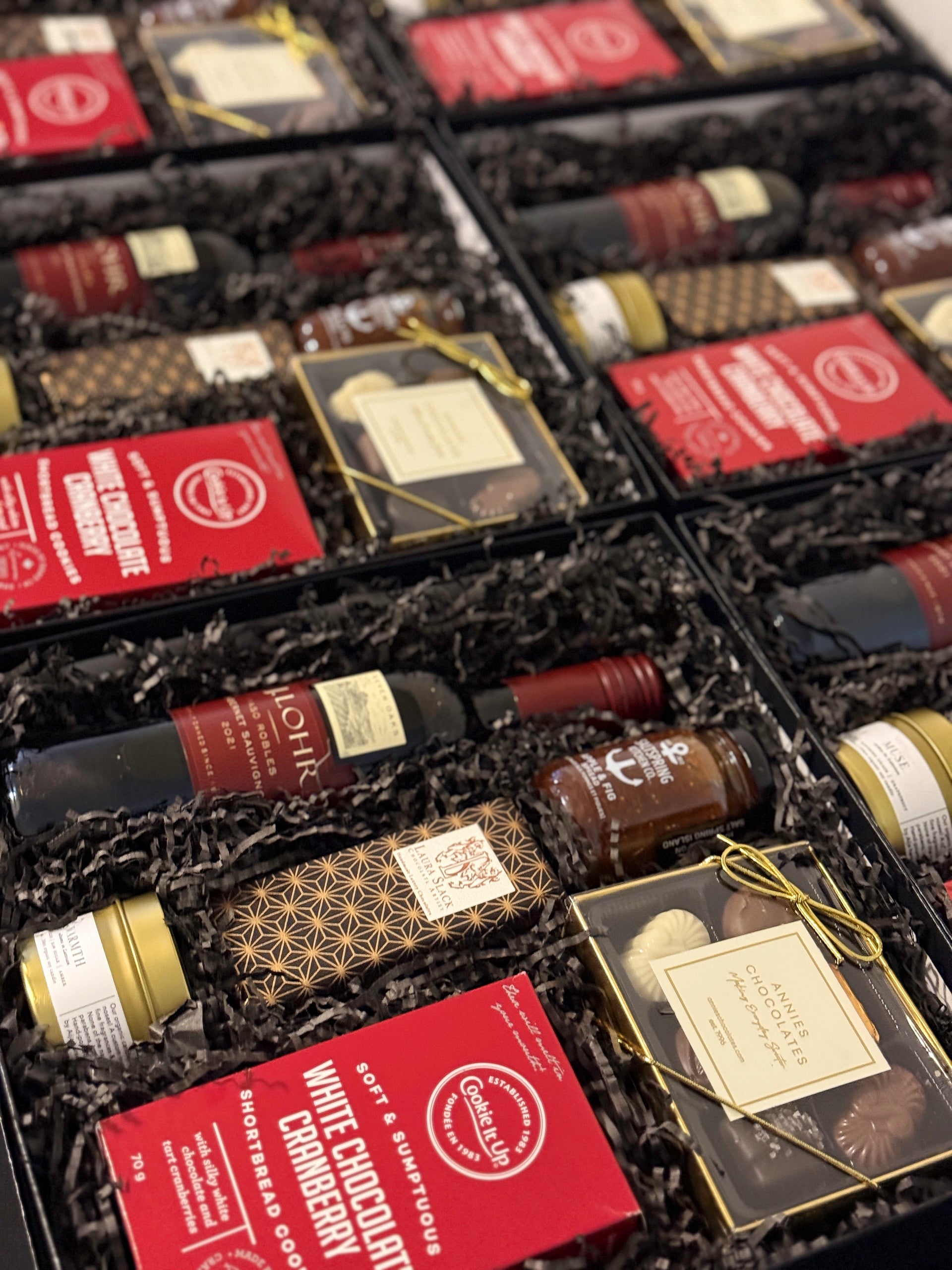 Assorted mini chocolate truffles in a gift box with visible brand labels.