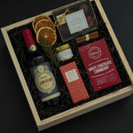 Curated Italian wine and chocolate gift box with festive seasonal details.