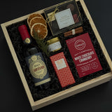 Curated Italian wine and chocolate gift box with festive seasonal details.
