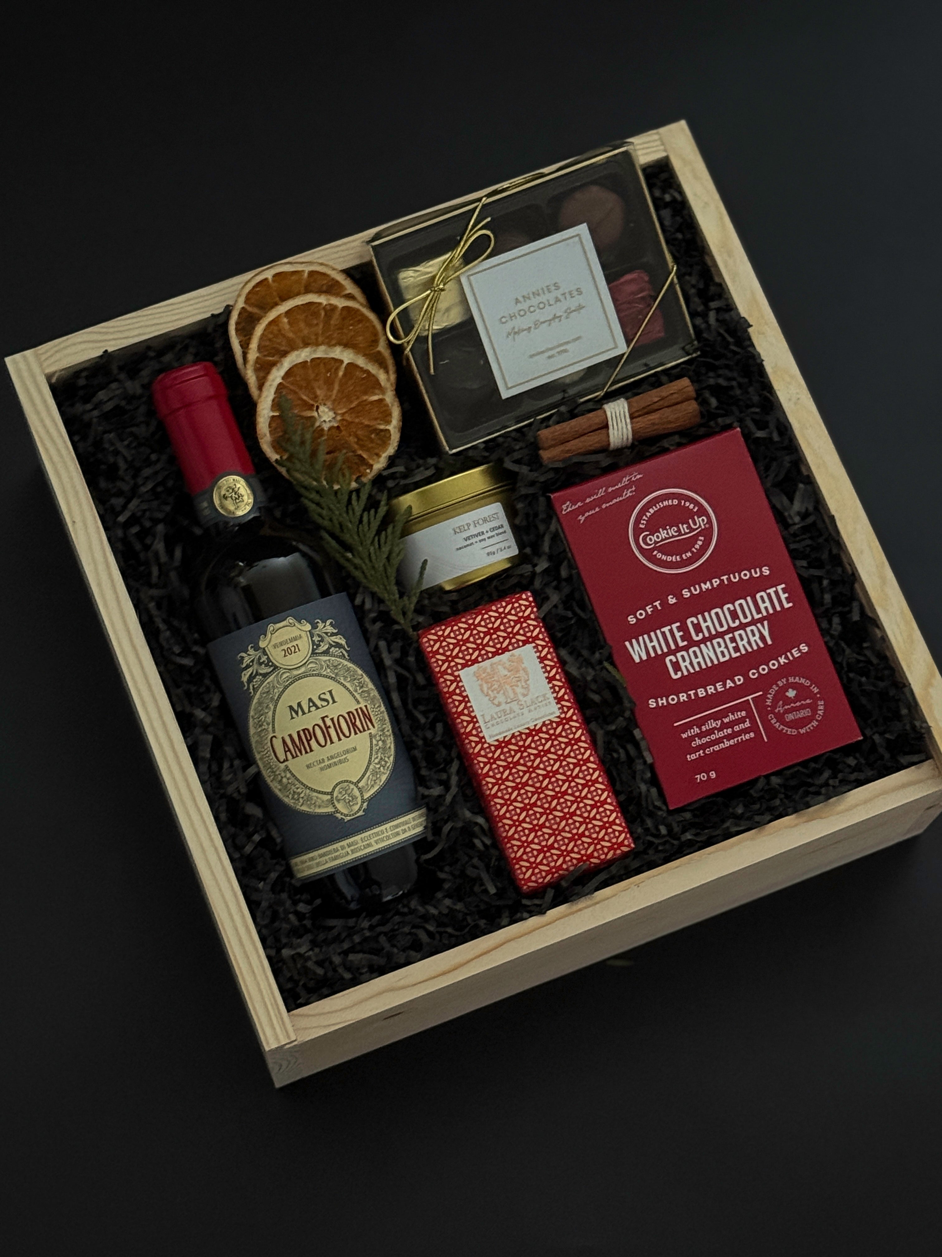 Curated Italian wine and chocolate gift box with festive seasonal details.