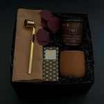 Nocturne holiday gift box with artisan candle, chocolate, stoneware cup, and linen napkin.