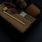 Holiday gift box with Crimson and Clover candle, terracotta cup, and artisan chocolate.