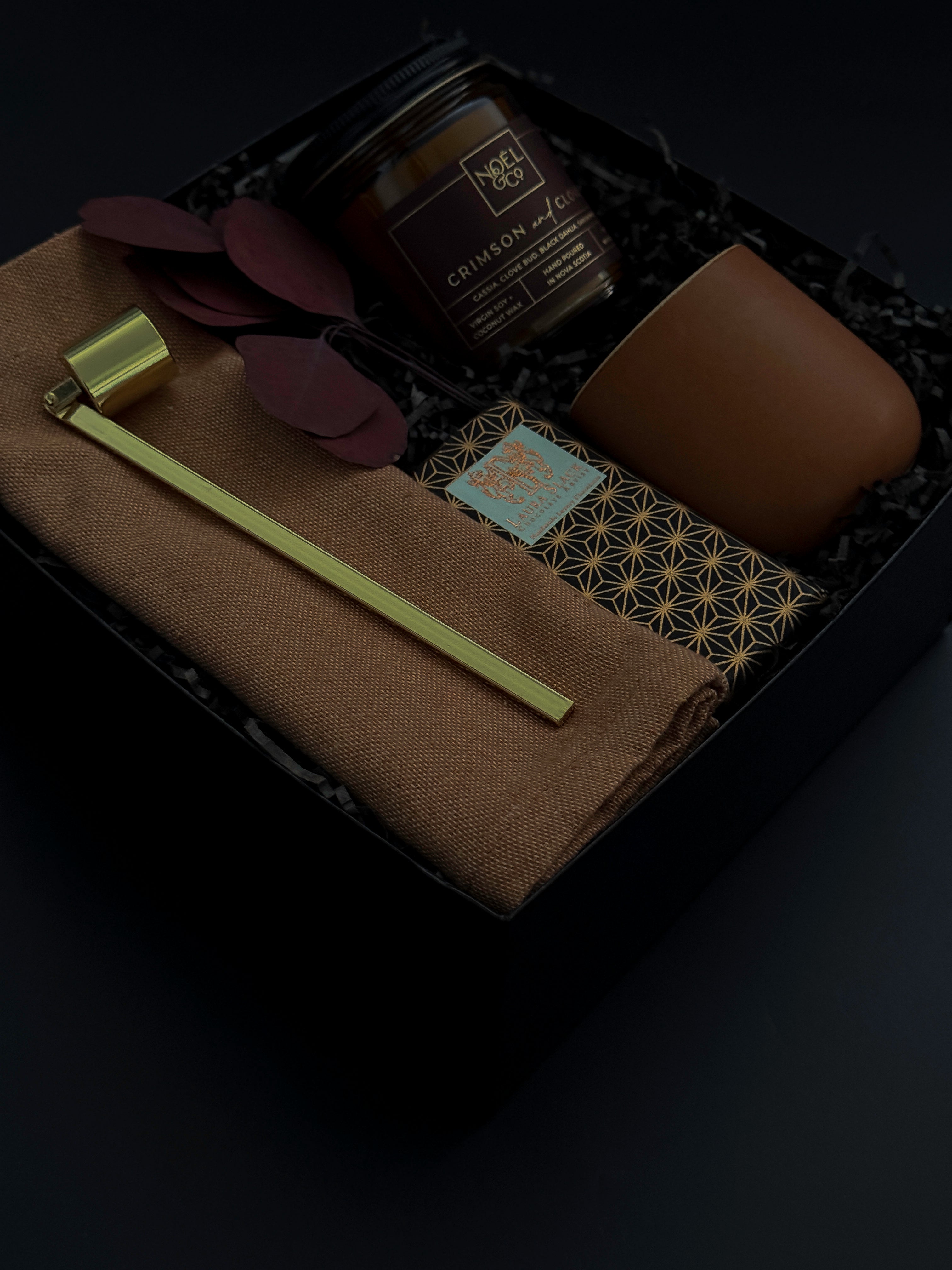 Holiday gift box with Crimson and Clover candle, terracotta cup, and artisan chocolate.