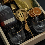 Corporate whiskey gift box featuring bourbon, Viski glasses, almonds, and festive details.