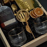 Corporate whiskey gift box featuring bourbon, Viski glasses, almonds, and festive details.