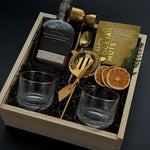 Corporate whiskey gift box featuring bourbon, Viski glasses, almonds, and festive details.