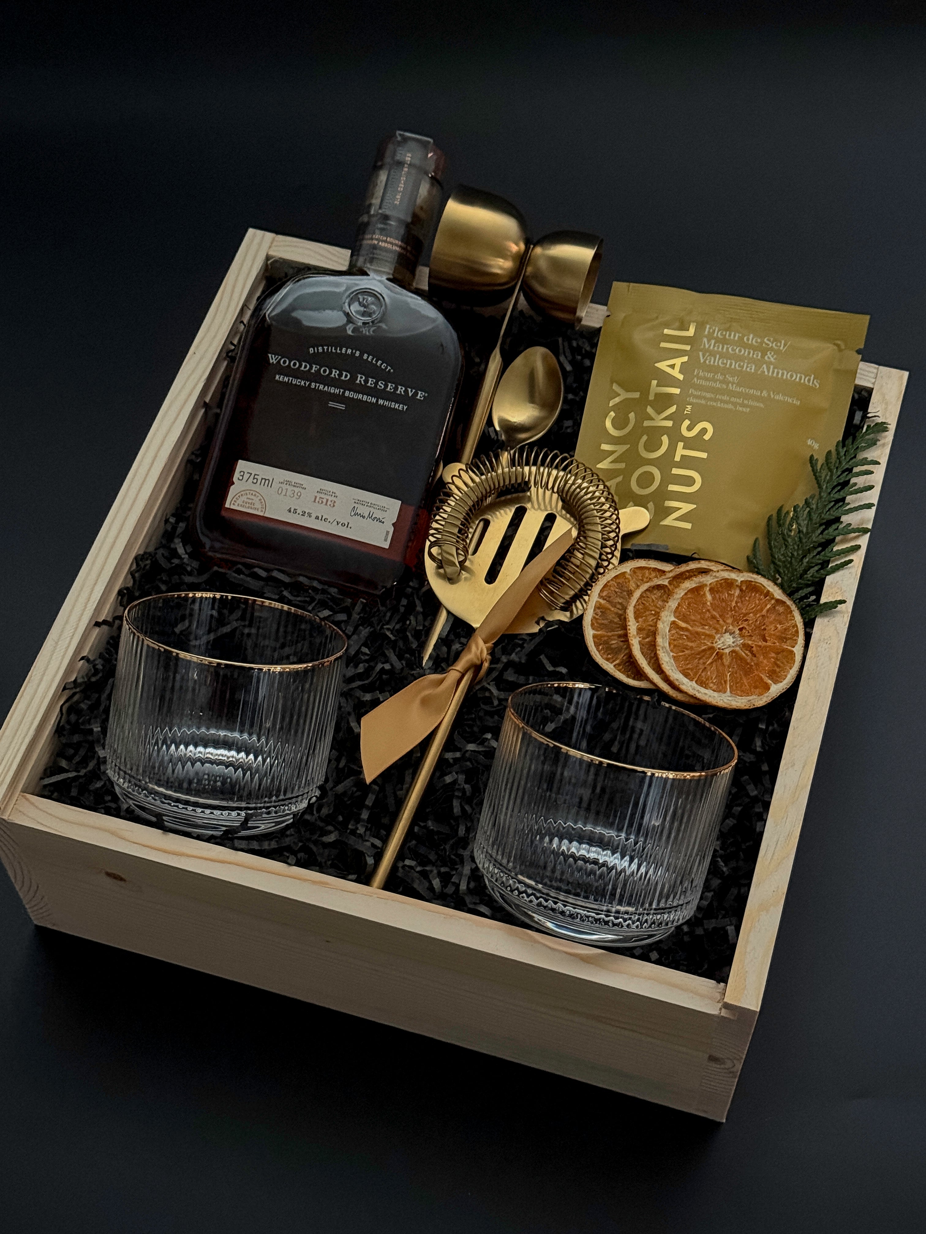 Corporate whiskey gift box featuring bourbon, Viski glasses, almonds, and festive details.