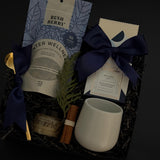 Elegant holiday wellness gift box with tea, chocolate, honey, and stoneware mug — perfect for client and corporate gifting.
