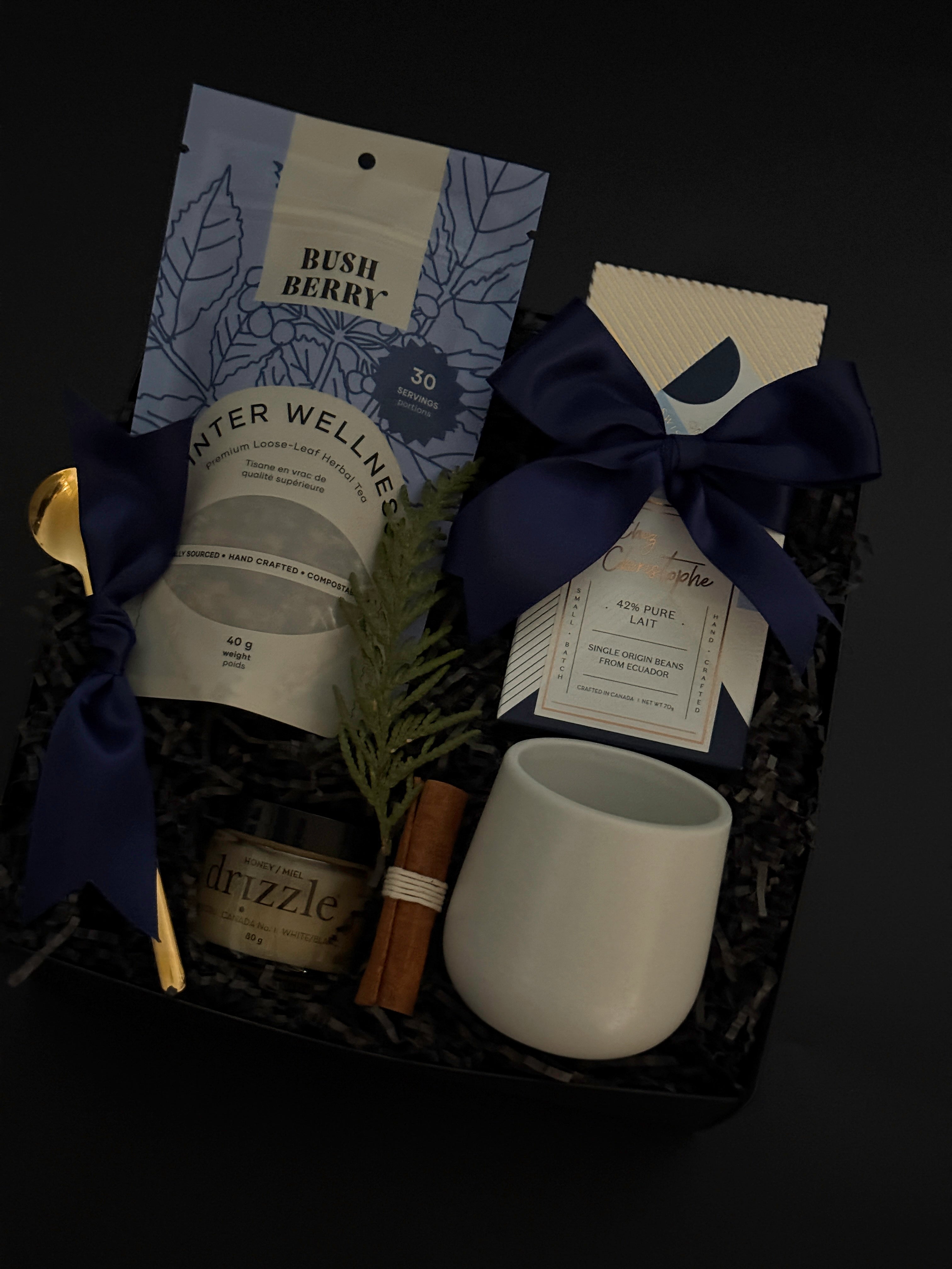 Elegant holiday wellness gift box with tea, chocolate, honey, and stoneware mug — perfect for client and corporate gifting.