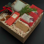 Corporate holiday gift box with stoneware cup, candy cane soap, chocolate, and greenery.