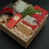 Corporate holiday gift box with stoneware cup, candy cane soap, chocolate, and greenery.