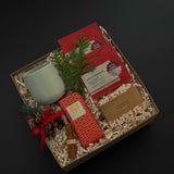 Executive holiday gift box with artisan chocolate, soap, cup, and festive ribbon.
