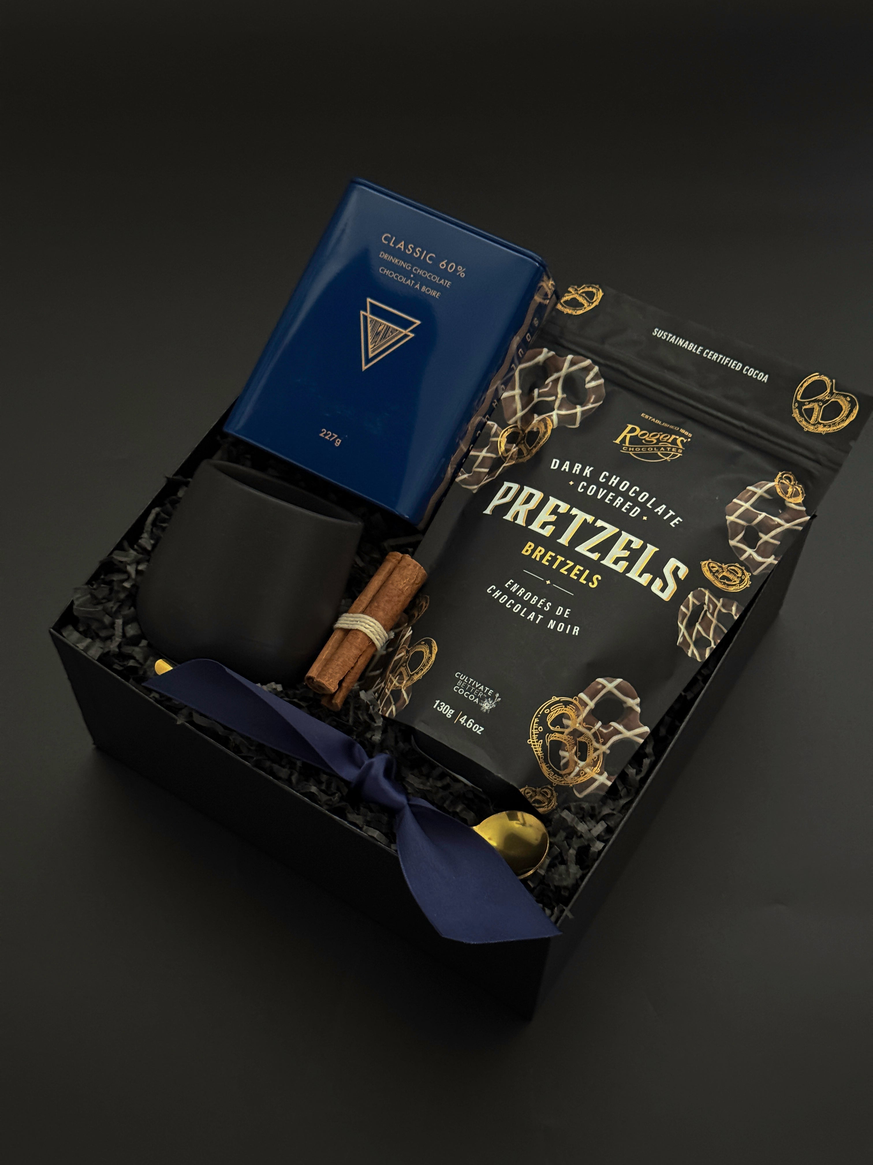 Flat lay of the Midnight Cocoa Gift Box featuring rich drinking chocolate, modern stoneware, and golden details, a luxurious take on a cozy winter ritual.