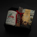 Corporate holiday gift box featuring a hot chocolate mug, chocolate truffles, and pretzels.