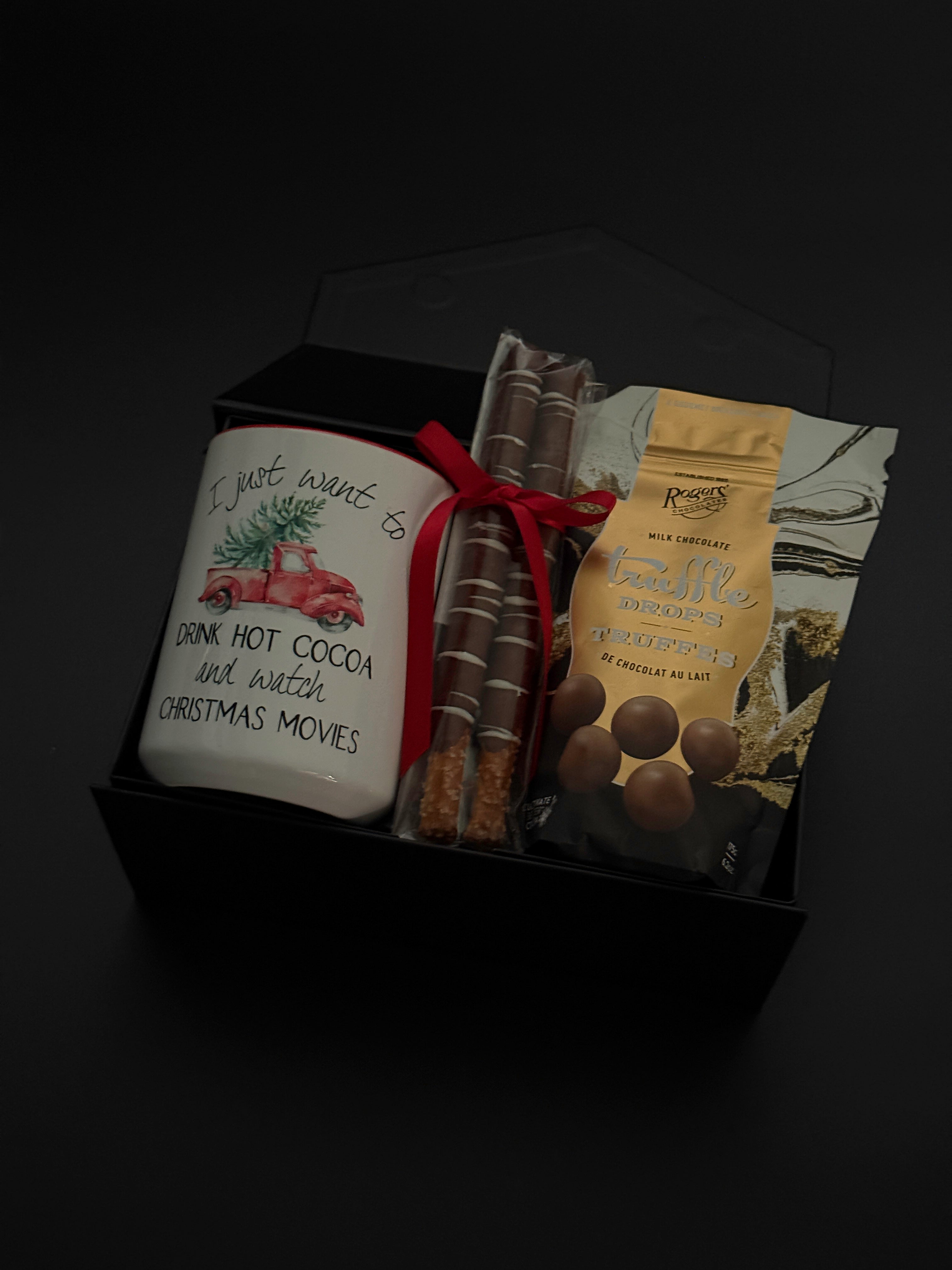 Corporate holiday gift box featuring a hot chocolate mug, chocolate truffles, and pretzels.
