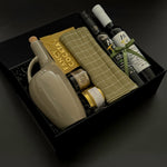 Client appreciation gift box featuring infused olive oil, balsamic, almonds, and stoneware dispenser.