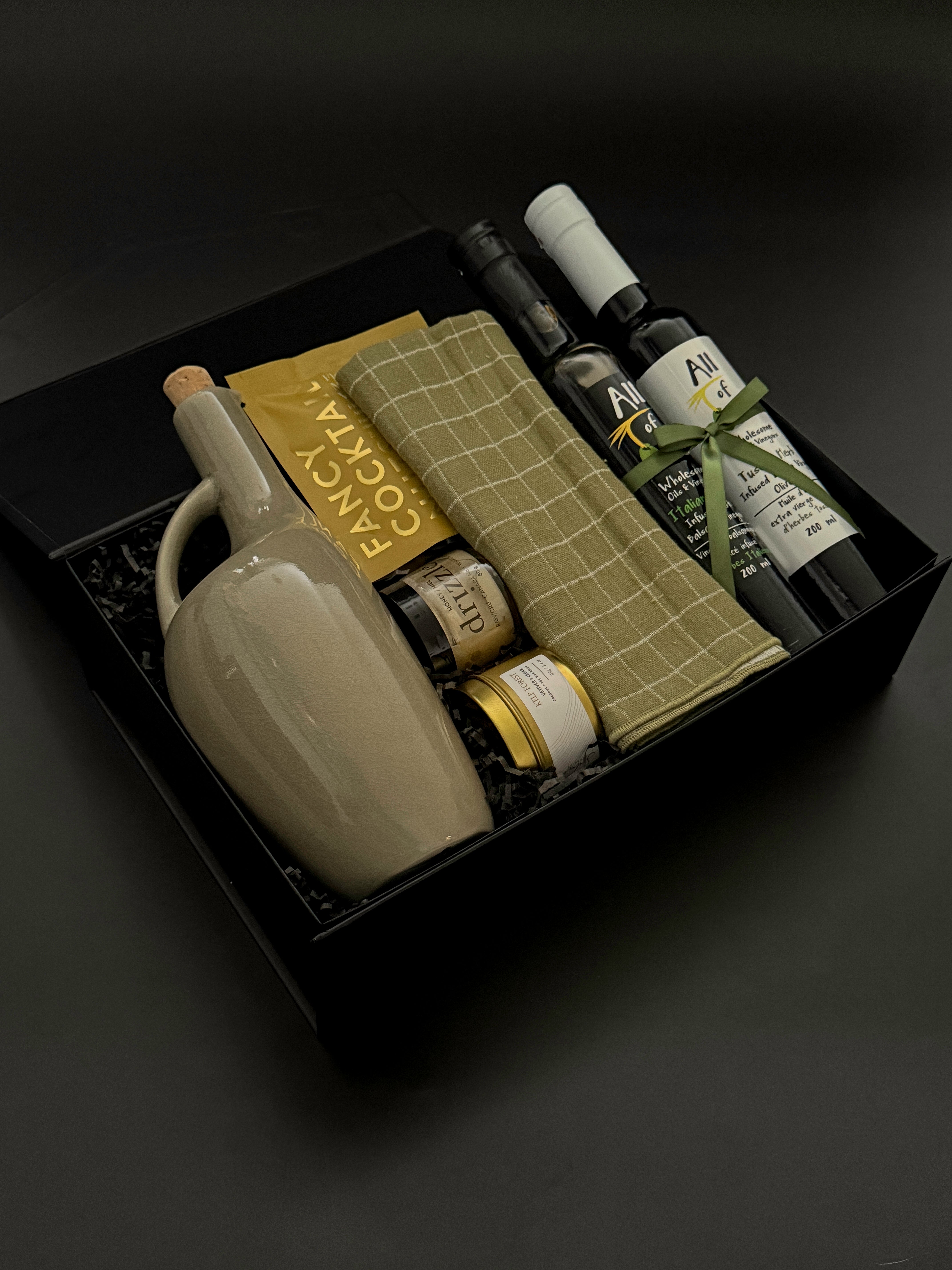 Client appreciation gift box featuring infused olive oil, balsamic, almonds, and stoneware dispenser.