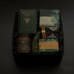 Étoile holiday gift box with sparkling wine, artisan chocolate, pretzels, and festive citrus accents.