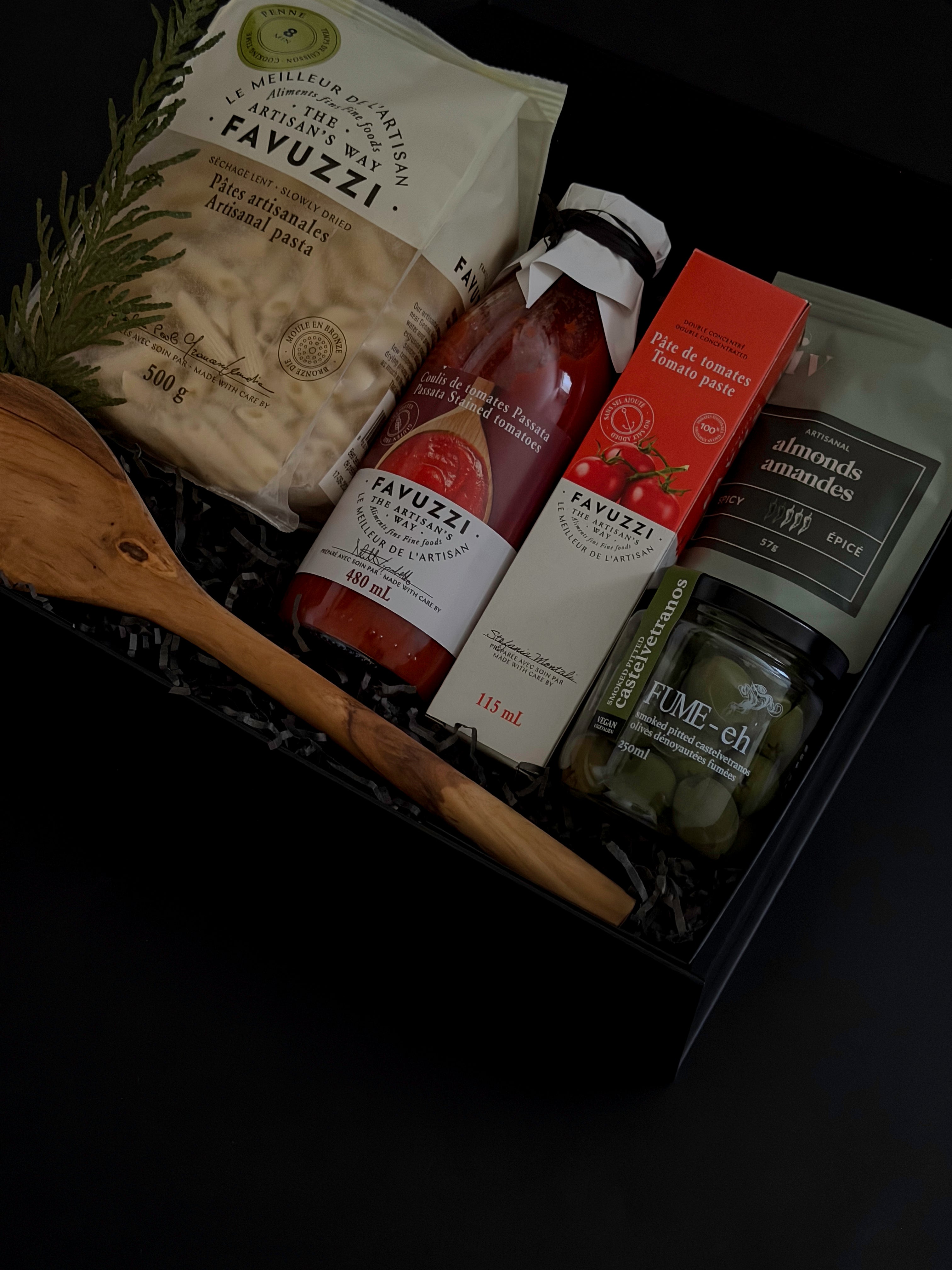 Olive wood spoon and Castelvetrano olives displayed beside the gift box — highlighting the elegant details and craftsmanship.