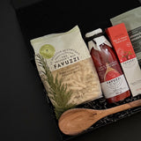 Favuzzi food products including a wooden spoon on a dark background