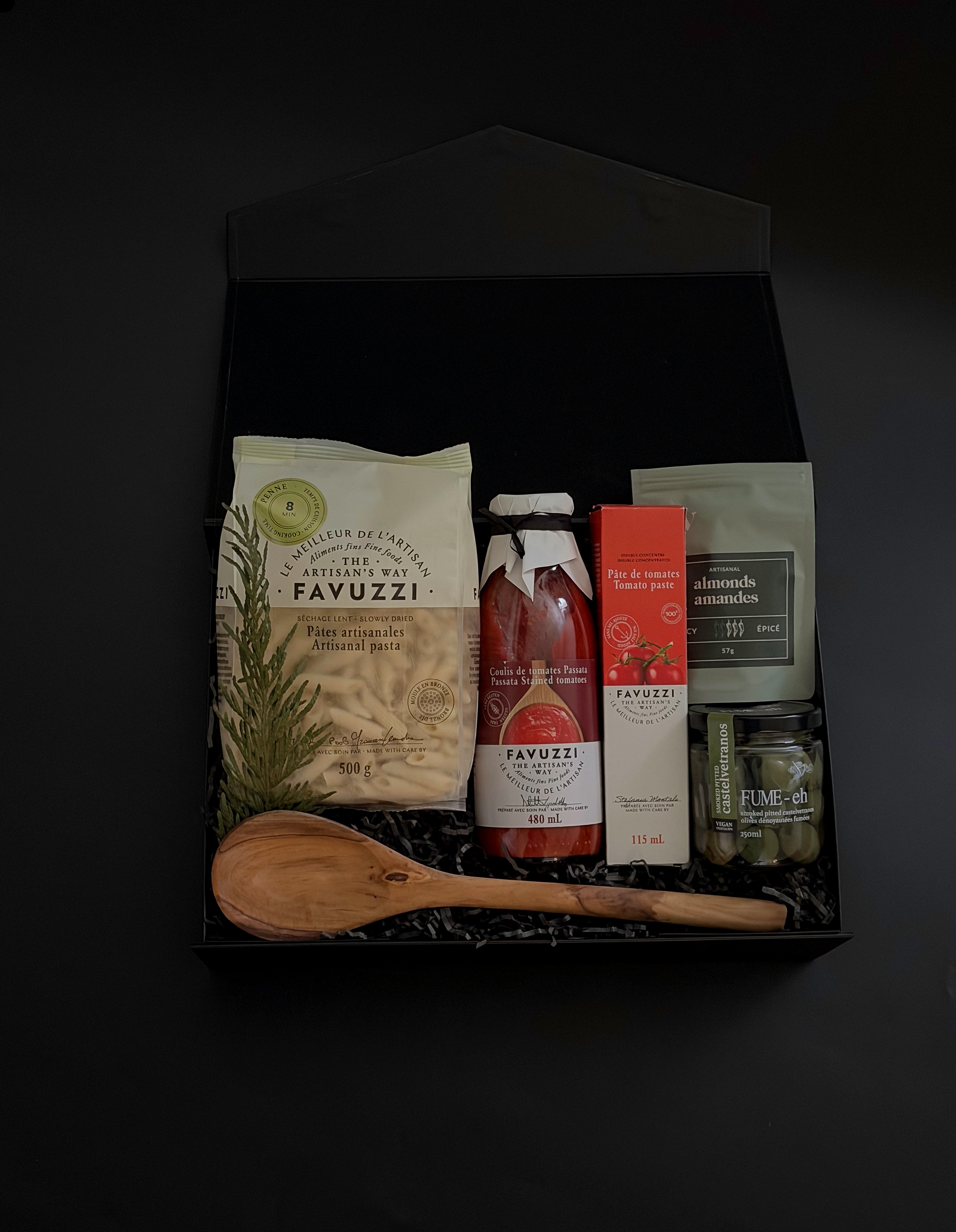 Flat lay of La Tavola Italiana Gift Box — black box filled with artisanal pasta, passata, and gourmet accompaniments, styled elegantly on a marble surface.