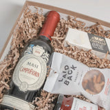 Luxury wine and cheese gift basket featuring Masi Campofiorin 2019, Castello brie, gourmet cashews, and artisanal red pepper jelly.