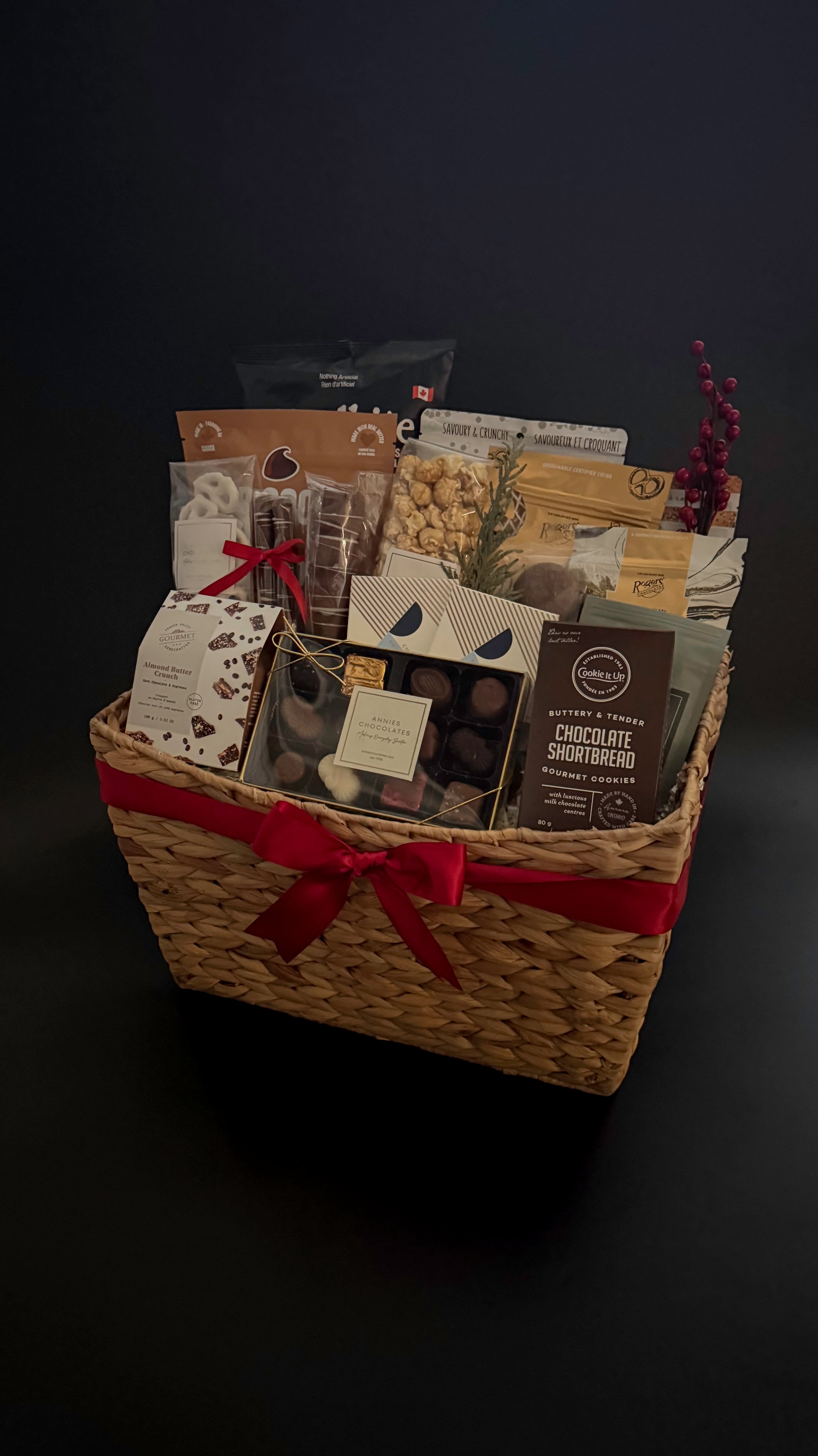 The Holiday Gathering Basket filled with gourmet chocolates and artisan snacks by Muse Baskets and Co.