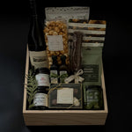 The Opulent Collection by Muse Baskets and Co. — luxury gift box featuring fine Chardonnay, artisan Canadian savouries, gourmet confections, and premium pantry essentials, elegantly arranged in a signature wood box.