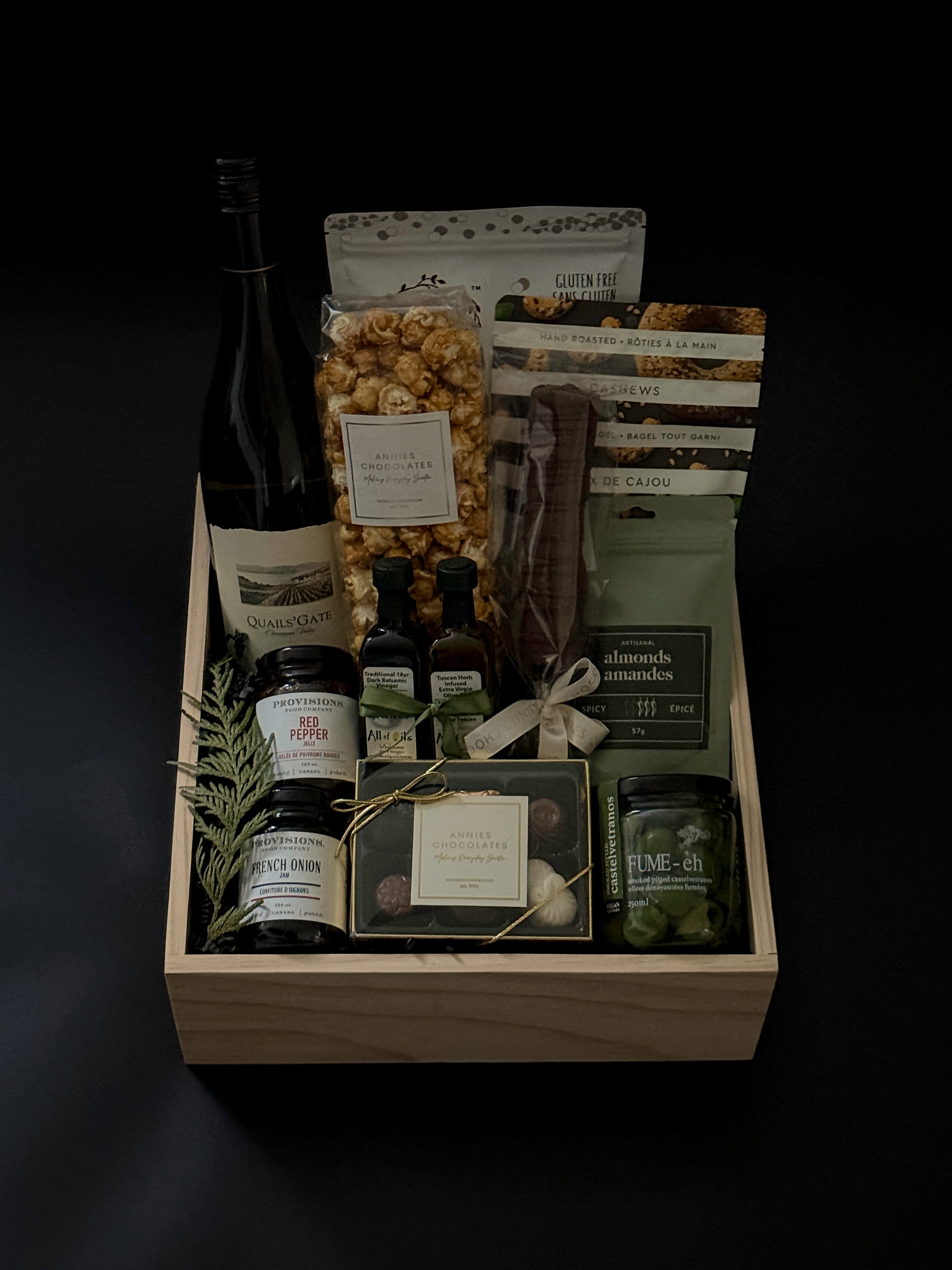 The Opulent Collection by Muse Baskets and Co. — luxury gift box featuring fine Chardonnay, artisan Canadian savouries, gourmet confections, and premium pantry essentials, elegantly arranged in a signature wood box.