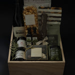 Close-up of artisan Canadian treats from The Opulent Collection — spiced nuts, smoked Castelvetrano olives, charcuterie jams, red pepper jelly, and chocolates arranged elegantly.