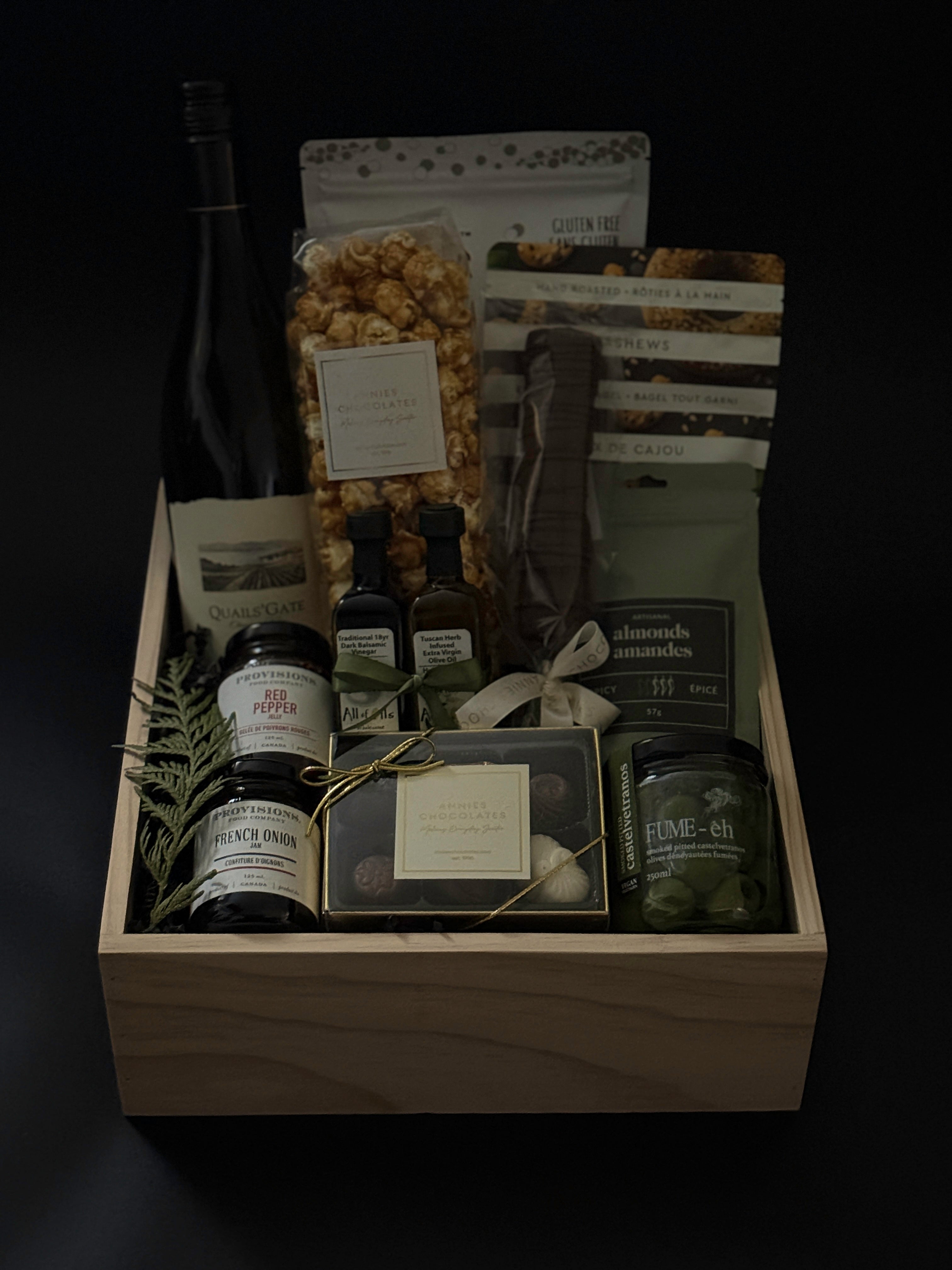 Close-up of artisan Canadian treats from The Opulent Collection — spiced nuts, smoked Castelvetrano olives, charcuterie jams, red pepper jelly, and chocolates arranged elegantly.