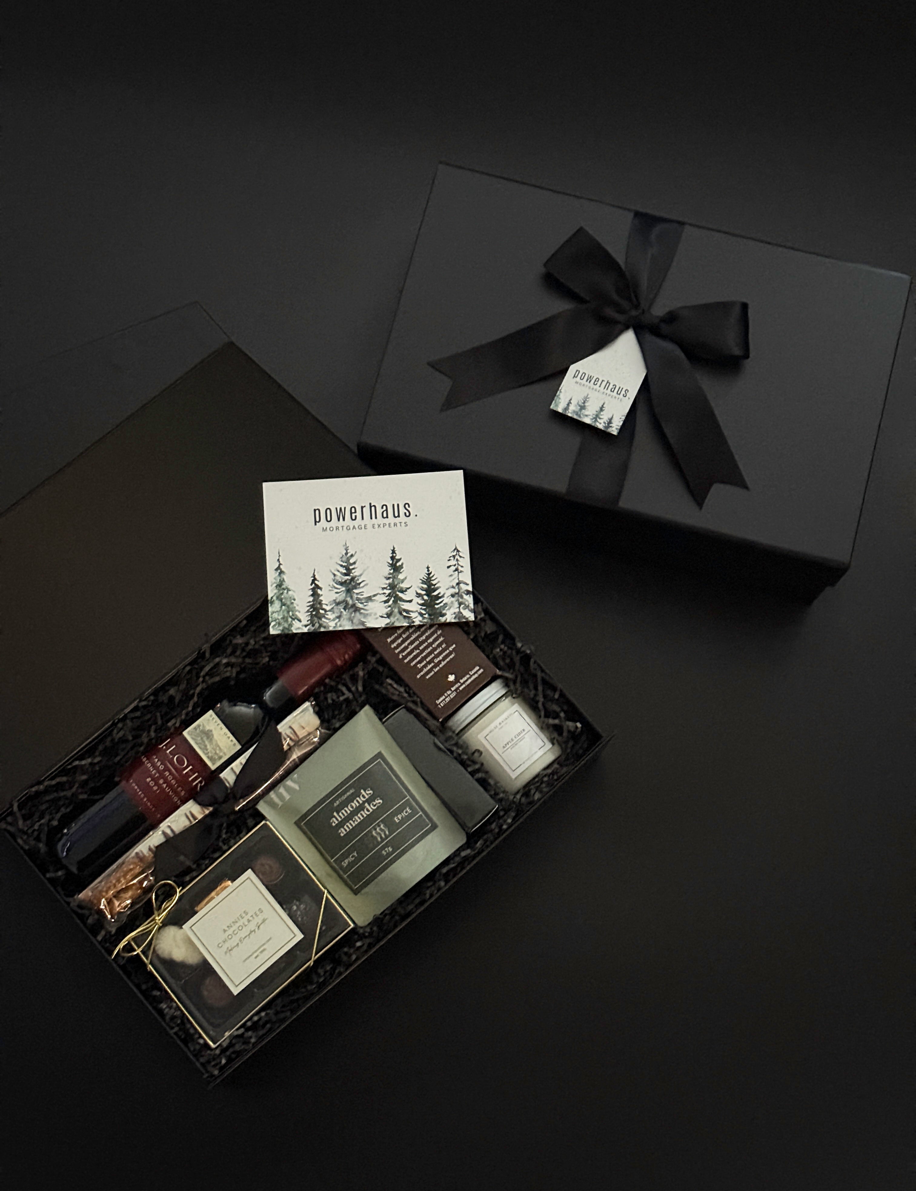 Luxury corporate gift box by Muse Baskets and Co. featuring artisanal candles, chocolates, wine, and wellness products, custom-branded for Powerhaus Mortgage Experts.