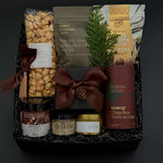 Elegant client appreciation gift box featuring sweet and savoury artisan foods and a gold tin candle.