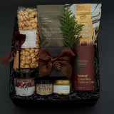 Elegant client appreciation gift box featuring sweet and savoury artisan foods and a gold tin candle.