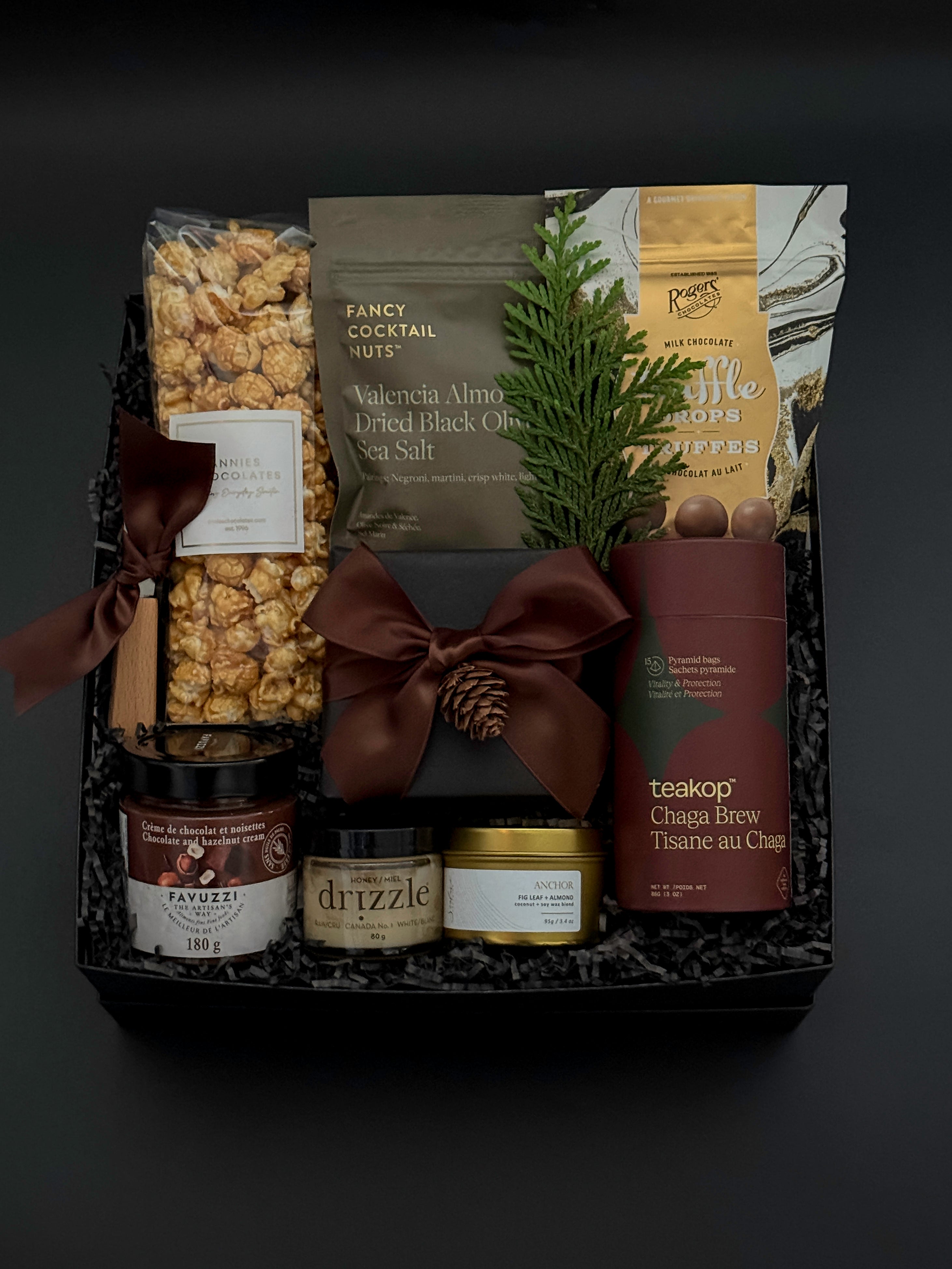 Elegant client appreciation gift box featuring sweet and savoury artisan foods and a gold tin candle.