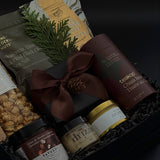 Elegant client appreciation gift box featuring sweet and savoury artisan foods and a gold tin candle.