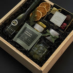 Client appreciation gift box with wine, gourmet almonds, chocolates, and festive presentation.