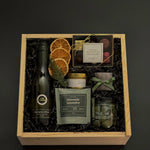 Eternal Glow holiday gift box with Sauvignon Blanc, chocolates, almonds, olives, and gold candle.